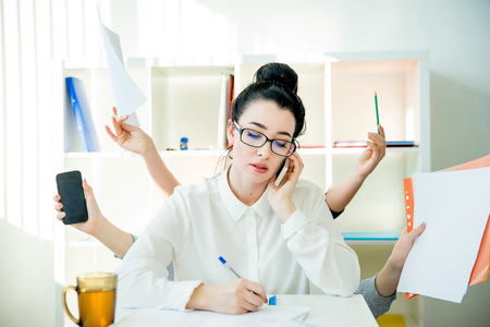 Successful businesswoman multitaskingの写真素材