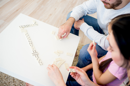 Family playing dominoの写真素材
