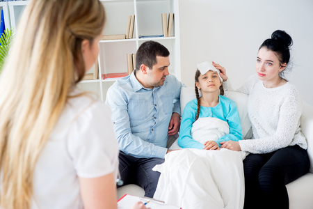 Doctor visiting sick girlの写真素材