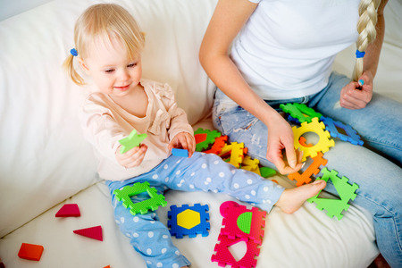 Mother playing with her baby daughterの写真素材