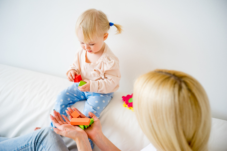 Mother playing with her baby daughterの写真素材