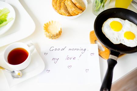 Couple eating breakfast early in the morning in the kitchenの写真素材