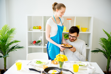 Wife cooking for husbandの写真素材