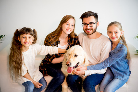 Family playing with a dogの写真素材