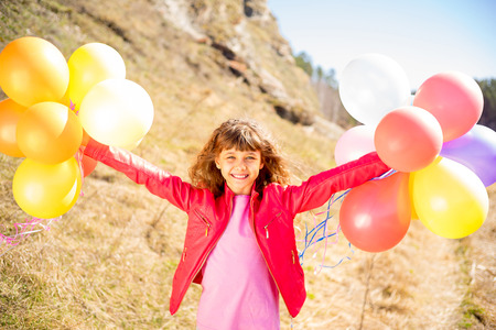 Girl playing with balloonsの写真素材