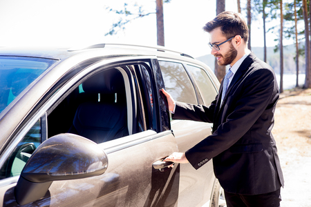 Happy man entering his carの写真素材