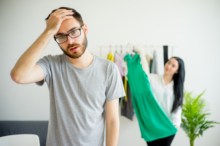 Bored husband waiting for wifeの写真素材