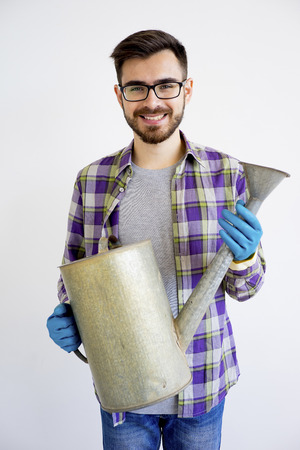 Male gardener with a watering potの写真素材