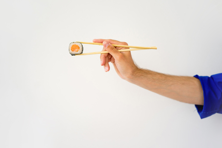 Delivery guy holding a japanese sushi rollの写真素材
