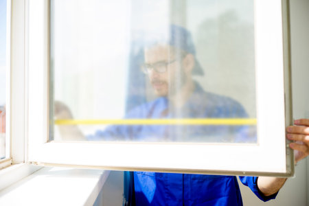 Construction worker installing window