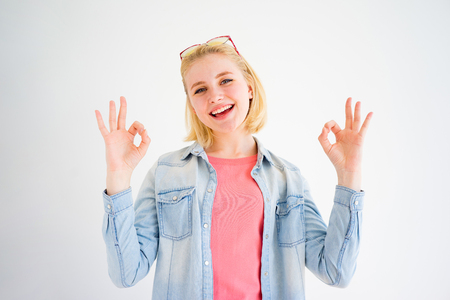 Stylish girl showing OK signの写真素材