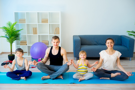 Family doing yoga togetherの写真素材