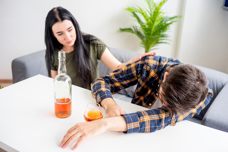 Wife with alcoholic husbandの写真素材