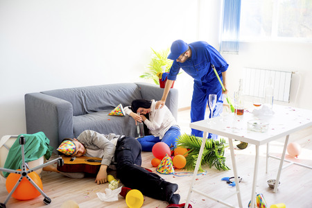 Janitor cleaning a messの写真素材