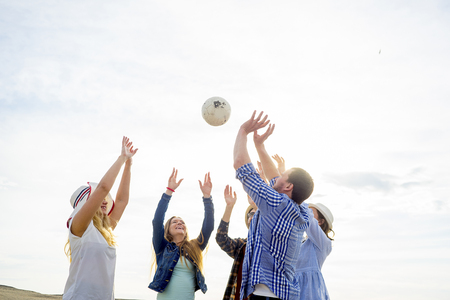 Friends playing volleyballの写真素材