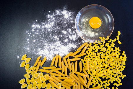 Various mix of italian pasta on a tableの写真素材