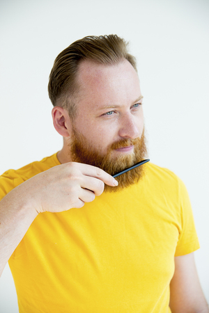 Guy trimming his beardの写真素材