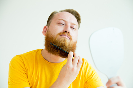 Guy trimming his beardの写真素材