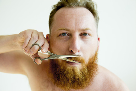 Guy trimming his beardの写真素材