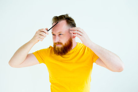 Guy trimming his beard