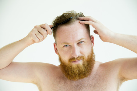 Guy trimming his beardの写真素材