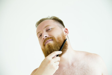 Guy trimming his beardの写真素材