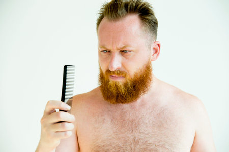 Guy trimming his beard