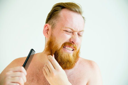 Guy trimming his beardの写真素材