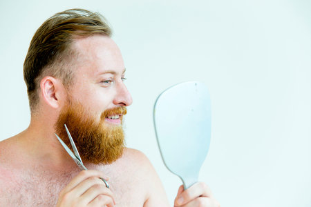 Guy trimming his beard