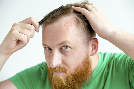 Guy trimming his beardの写真素材