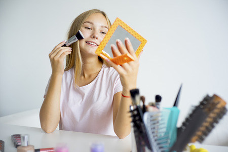 Girl applying makeupの写真素材