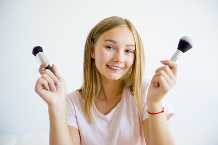 Girl applying makeupの写真素材