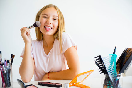 Girl applying makeupの写真素材