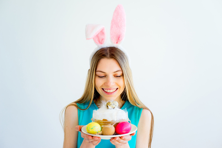 Girl with bunny ears and colored eggsの写真素材