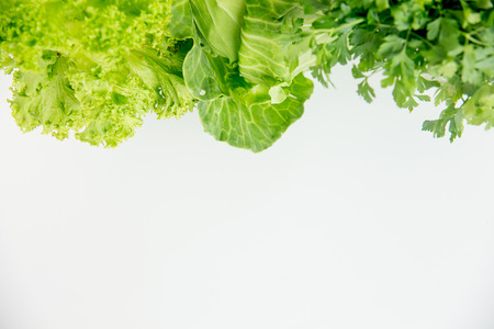 Creative layout of different fresh vegetables on a tableの写真素材