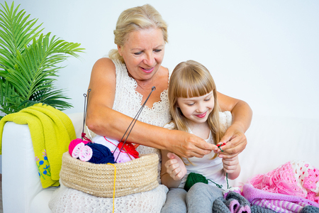 Grandmother knitting with granddaughterの写真素材