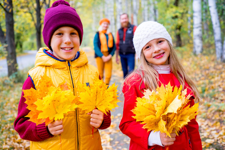 Family in an autumn parkの写真素材