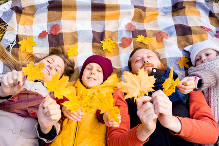 Family in an autumn parkの写真素材