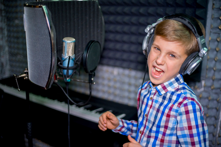 Boy in a recording studioの写真素材