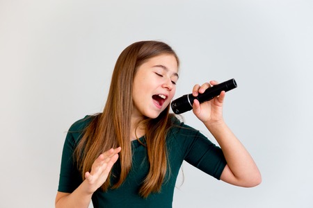 Girl singing with a microphoneの写真素材