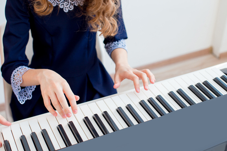 Girl playing synthesizerの写真素材