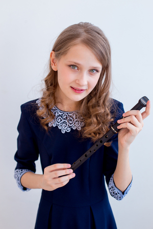 Girl playing on a fluteの写真素材