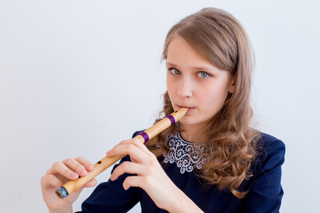 Girl playing on a fluteの写真素材