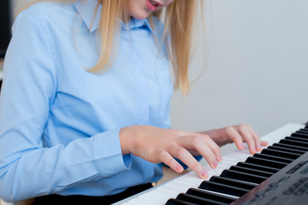 Girl playing synthesizerの写真素材
