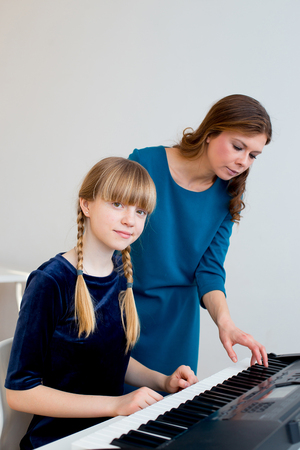 Girl playing synthesizerの写真素材