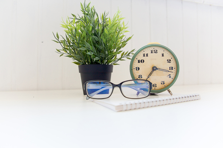 Retro alarm clock on a wite tableの写真素材