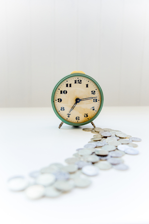 Retro alarm clock on a wite tableの写真素材