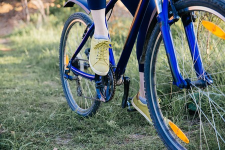 Young woman riding a bike in a parkの写真素材