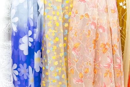 Rolls of colorful fabric and textiles in a shop or storeの写真素材