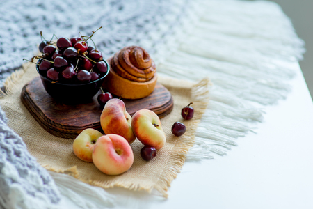 Homemade cinnamon buns in glaze on a dark plate with berriesの写真素材